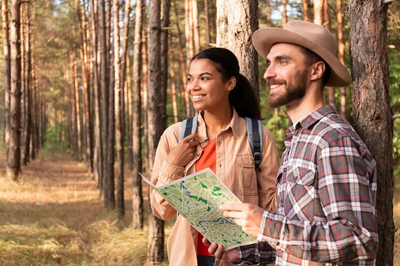 Side view of a couple looking away in nature, with copy space.