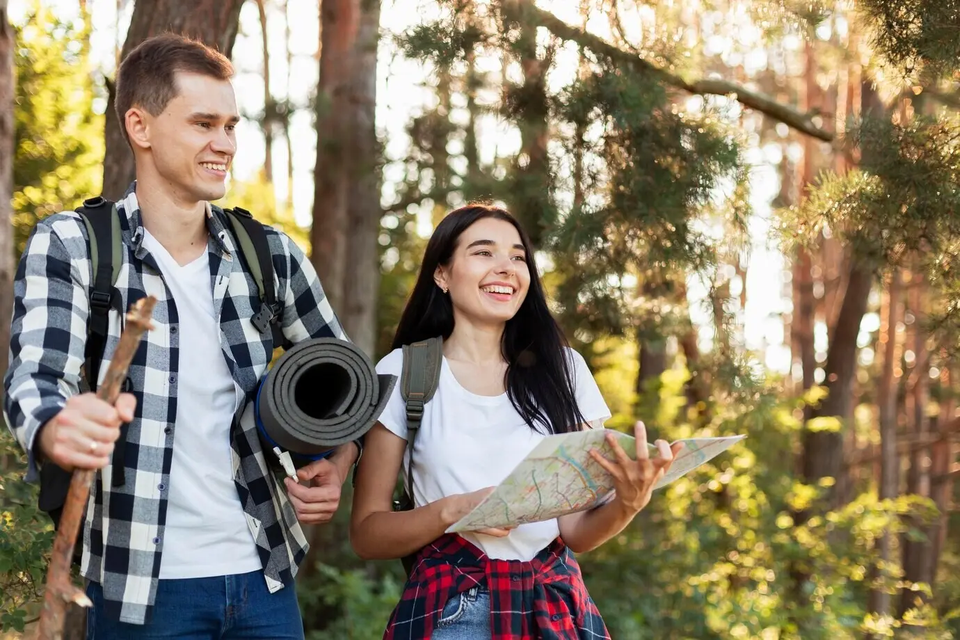 Front view of a young couple walking in nature.